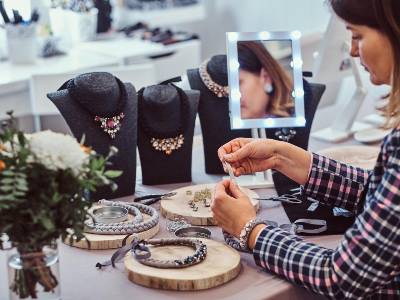Customers exploring jewellery in a store with staff assistance